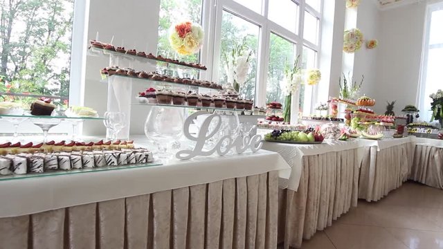 LOVE sign board ,delicious decorated sweets on buffet table, cocktail catering