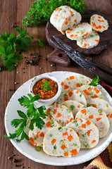 Fish roll (roulade) with green peas and carrots