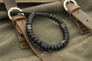 Black Paracord Bracelet on a Canvas and Leather Backpack 1