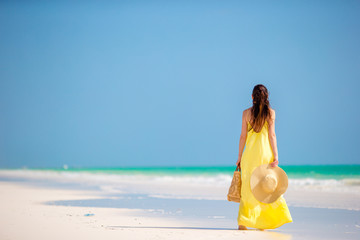 Young woman in hat during tropical beach vacation