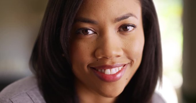 Close up of beautiful black female indoors smiling at camera
