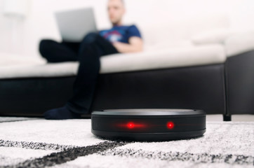 Robotic vacuum cleaner on carpet.