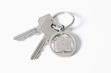 House key on a house shaped pendant