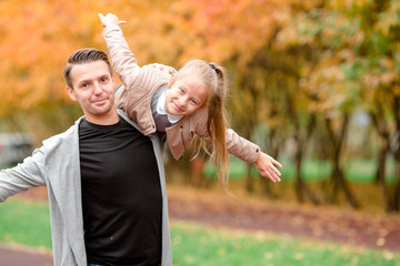 Fototapeta premium Family of dad and kid having fun on beautiful autumn day