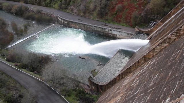 Side view of huge gush of water coming at the point of evacuation of a dam or reservoir dam 