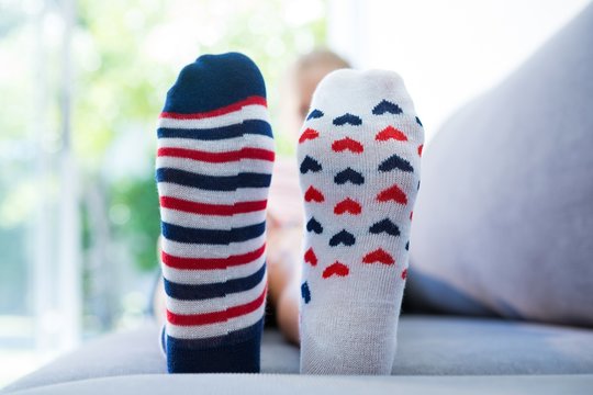 Close Up Of Girl Wearing Different Socks