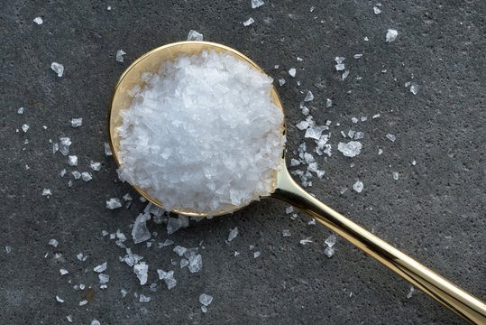 Sea Salt Flakes On A Gold Spoon