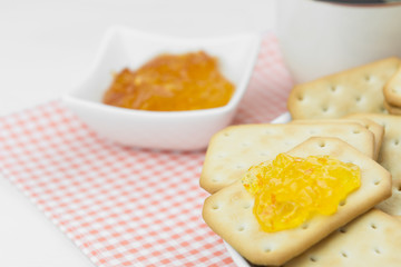 crackers with orange jam on cotton fabric, close up. selective focus.