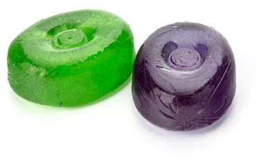 Two colorful fruit hard sugar candies,  boiled sweeties or sugar plums isolated on white background cutout
