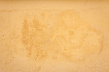 Yellow painted old concrete wall texture background