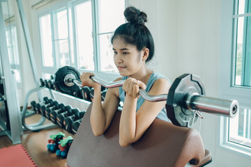 Plakat Woman exercising with dumbbell.