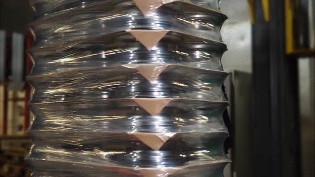 Several layers of rims wrapped up on the machine. Ready to go on pallets.