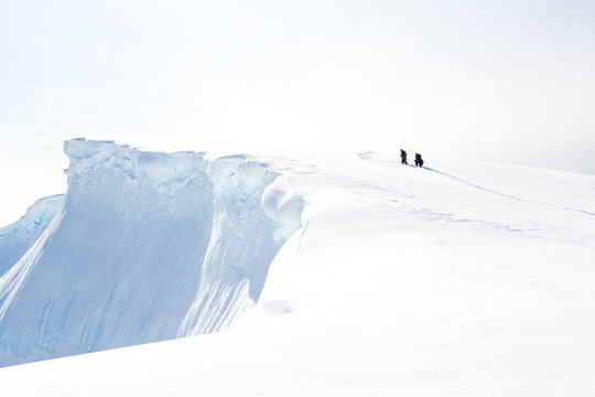 View of people walking on glacier, Antarctica