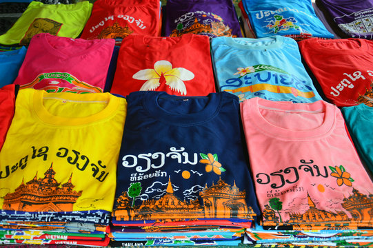 Colorful t-shirts with Lao tourist attractions screen printing sold at souvenir shop in Vientiane, capital city of Lao PDR.