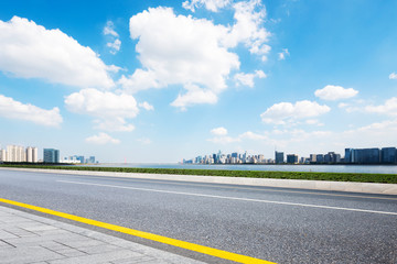 empty asphalt road with cityscape of modern city