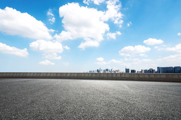 Fototapeta premium empty asphalt road with cityscape of modern city