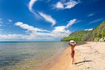 A girl on a sandy beach on a lake baikal