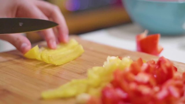 Chopping peppers on a cutting baord