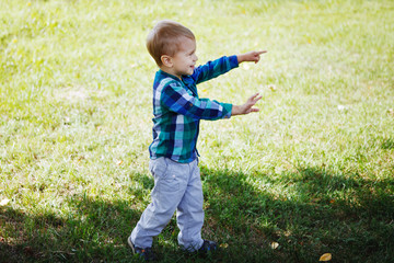 Little boy having fun playing in the Park on the grass