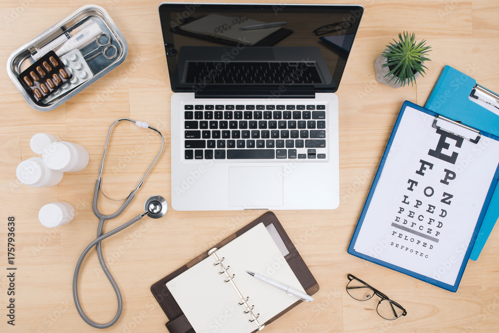 Aufkleber top view of doctor desk table with stethoscope and notebook with a visual test chart