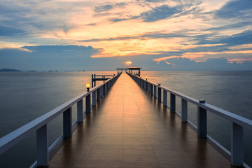 Fototapeta na wymiar Wooded bridge in the port along sunrise.Wooden pier between sunset in Phuket, Thailand. Summer, Travel, Vacation and Holiday concept.