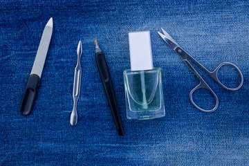 Basic set of manicure tools on jeans background