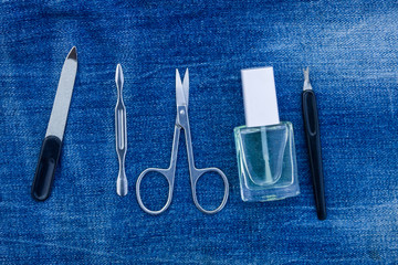 Basic set of manicure tools on jeans background