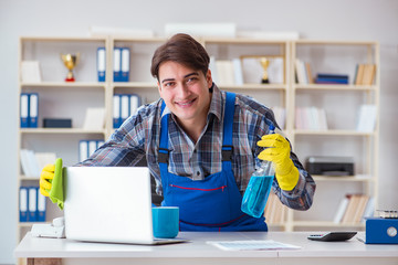 Male cleaner working in the office