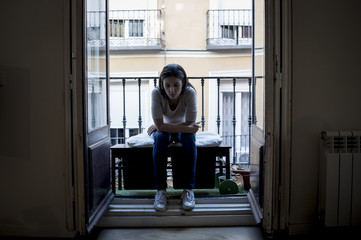 desperate sad Latin woman at home balcony looking devastated and depressed suffering depression