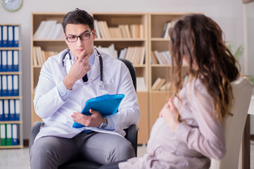 Fototapeta premium Pregnant woman visiting doctor for consultation