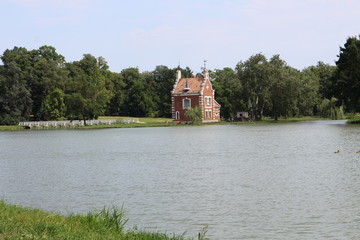 Obraz premium Holland house (A Holland Ház) on isle in garden of Classicist manor house in Dég, Hungary 