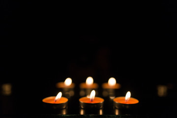 Many burning candles with shallow depth of field