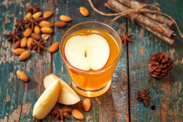 Hot drink of apple tea with cinnamon stick. Hot drink with apples for autumn or winter.