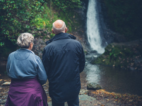 Senior couple admiring waterfall