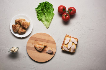 Obraz na płótnie Canvas Multiple ingredients combined into a chicken sandwich