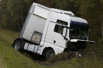 road accident lorry car crash on an highway lane road. Automobile in side ditch 