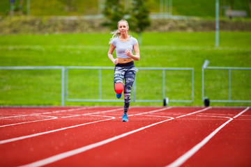 Young Female In Sportswear Running On Sports Tracks