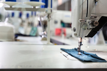 Sewing machine on textile fabric closeup, nobody