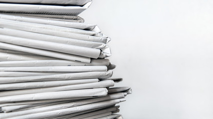 stack of newspapers, pile of journals on white background