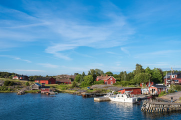 Fototapeta na wymiar Nötö island during the daytime pier and colourful red wooden houses