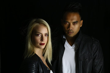 vampire couple posing on a black background 