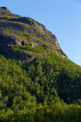 Fototapeta premium The mountain slope illuminated by the sun at sunset.