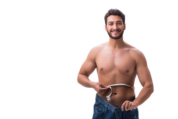 Fototapeta premium Man in dieting concept with oversized jeans