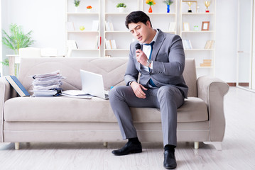 Sad businessman singing in office