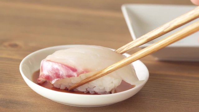eating nigiri sushi with red snapper