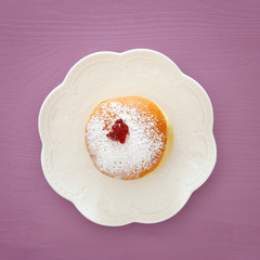 jewish holiday Hanukkah image background with traditional spinnig top, menorah (traditional candelabra), doughnut and candles