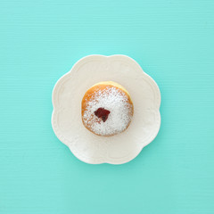 jewish holiday Hanukkah image background with traditional spinnig top, menorah (traditional candelabra), doughnut and candles