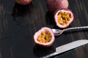 ripe passion fruit on black with...