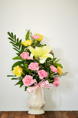 Bouquet of flowers in vase on wooden table