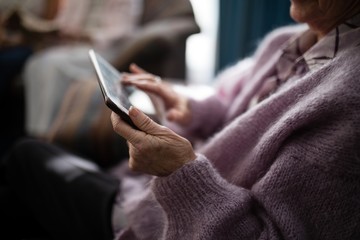 Midsection senior woman using digital tablet